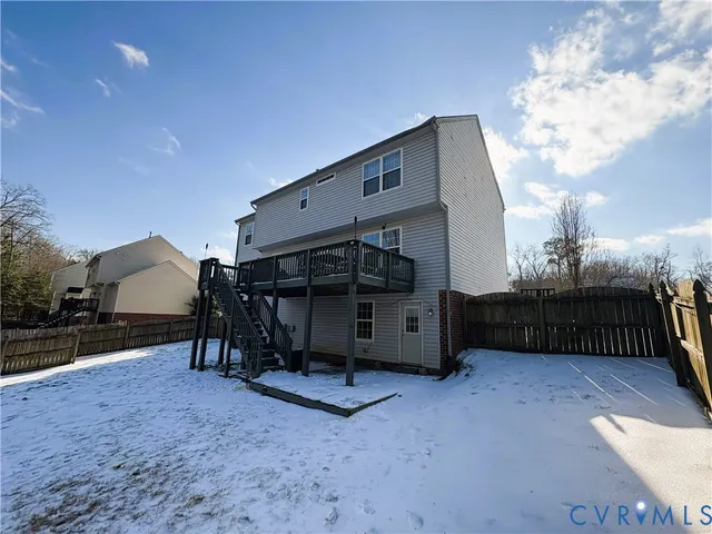 a view of a white house with a yard table and chairs