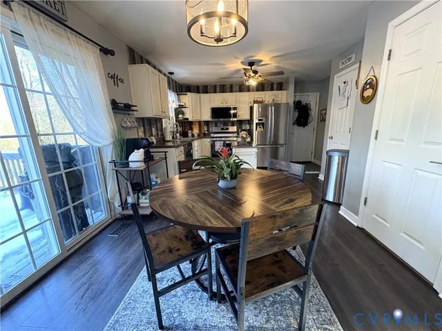 a view of a dining room with furniture and a chandelier
