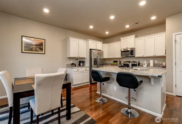 a kitchen with a dining table chairs and view of kitchen