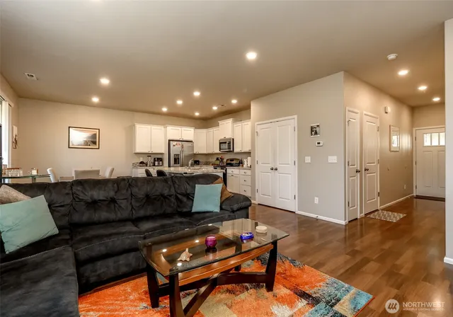 a living room with furniture and kitchen view