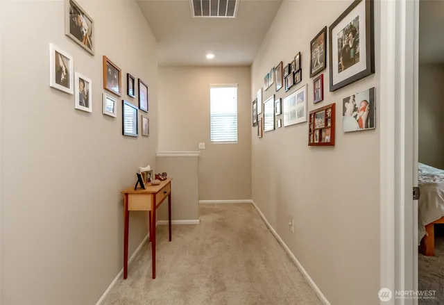 a view of a hallway with seating area