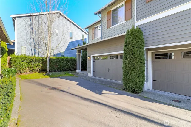 a view of a house with a yard and garage