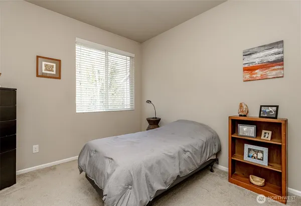 a bedroom with a bed and a book shelf