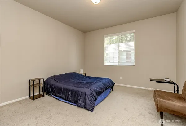 a living room with a bed furniture and a window