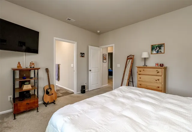a bedroom with a bed and a flat screen tv