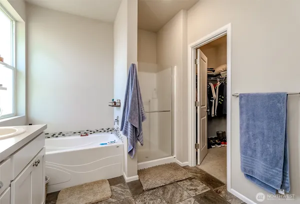 a bathroom with a tub and a sink