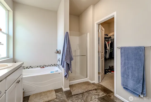 a bathroom with a tub and a sink