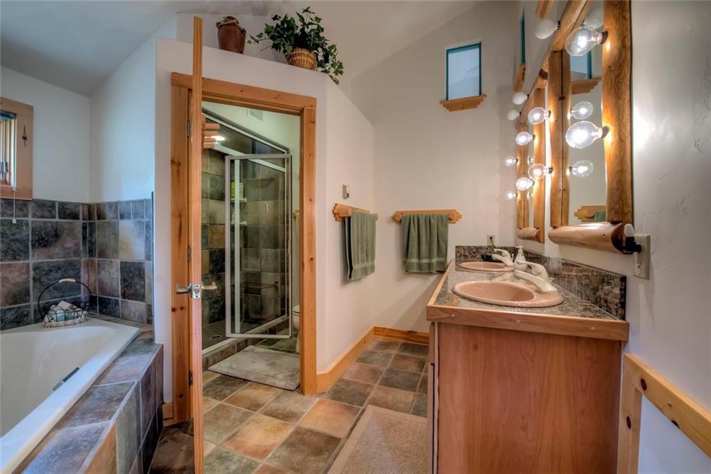 482 Idlewild Drive Dillon, CO 80435 - Photo 11 of 35 a en suite bathroom with a sink and a mirror