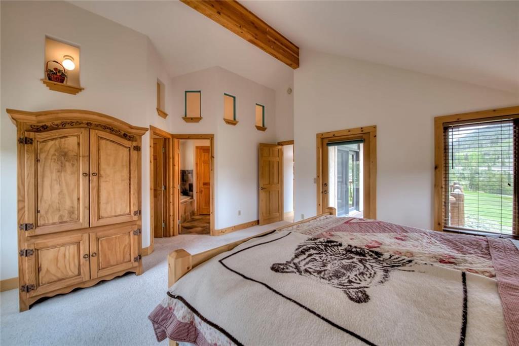 482 Idlewild Drive Dillon, CO 80435 - Photo 12 of 35 a bedroom with a bed and dresser with mirror