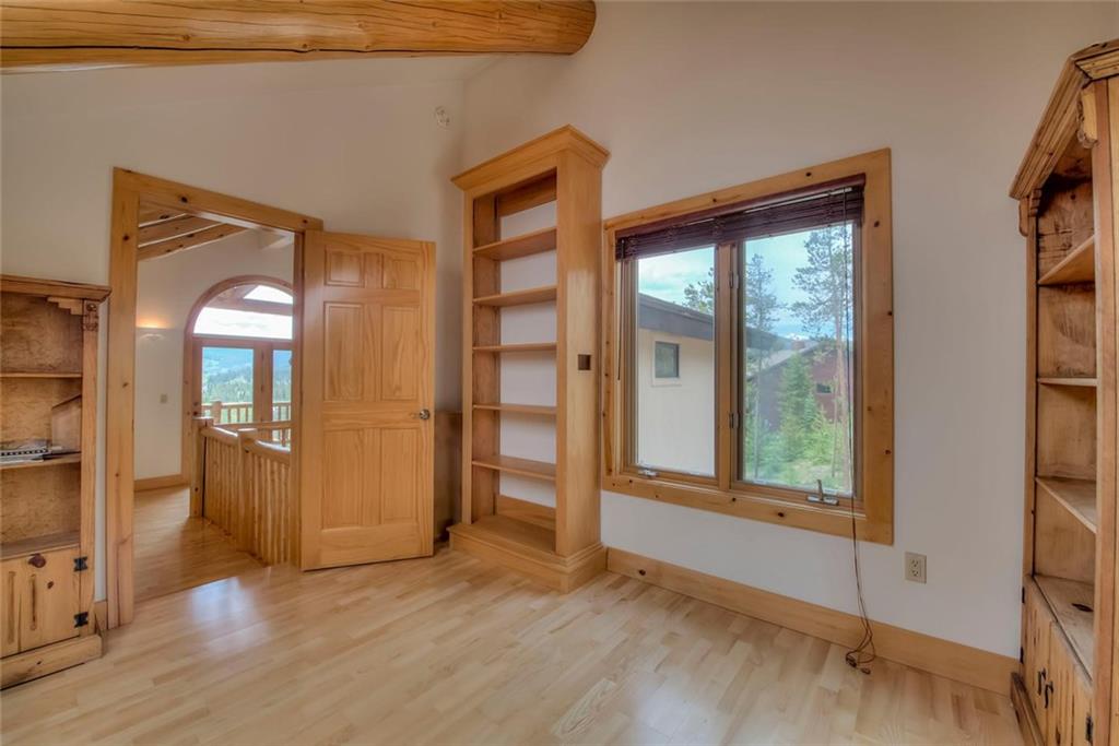 482 Idlewild Drive Dillon, CO 80435 - Photo 13 of 35 an empty room with wooden floor and windows