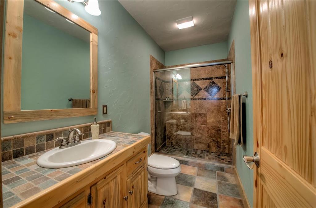 482 Idlewild Drive Dillon, CO 80435 - Photo 22 of 35 a bathroom with a sink toilet and shower