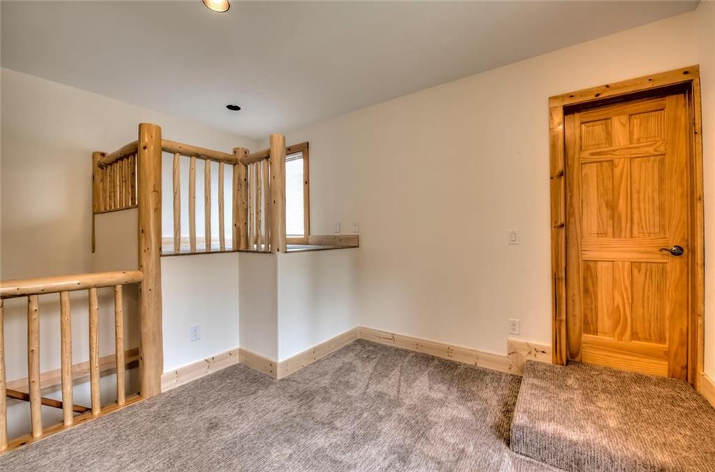 482 Idlewild Drive Dillon, CO 80435 - Photo 24 of 35 an empty room with wooden floor and door