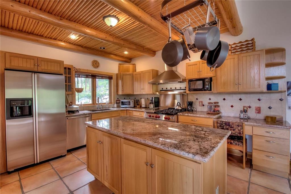 482 Idlewild Drive Dillon, CO 80435 - Photo 5 of 35 a kitchen with stainless steel appliances granite countertop a sink a stove and a refrigerator