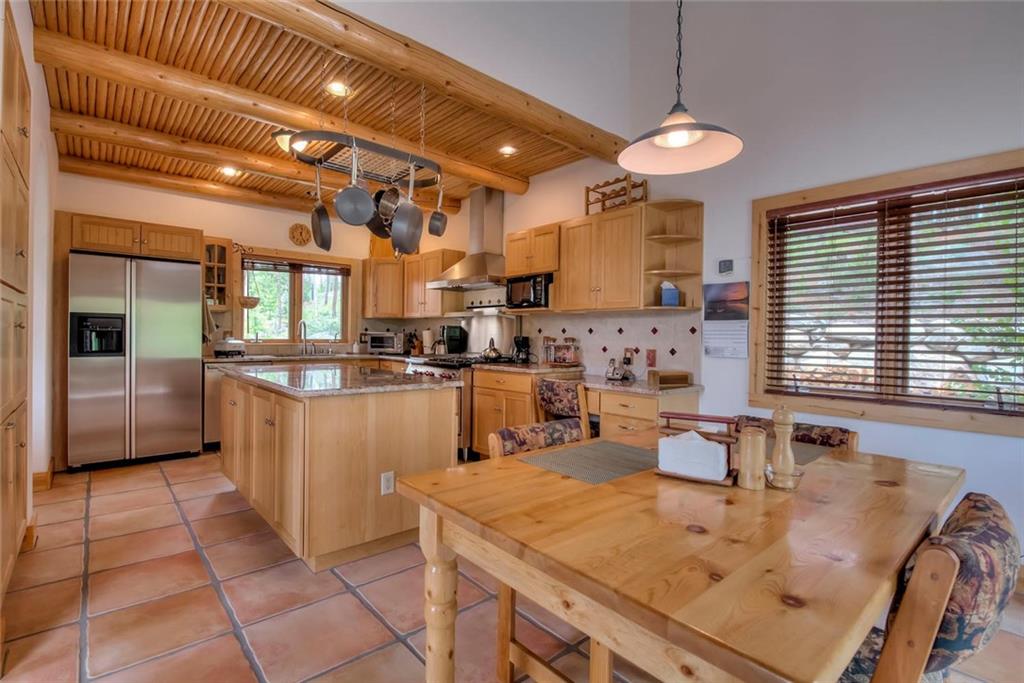 482 Idlewild Drive Dillon, CO 80435 - Photo 7 of 35 a kitchen with sink a refrigerator and chairs