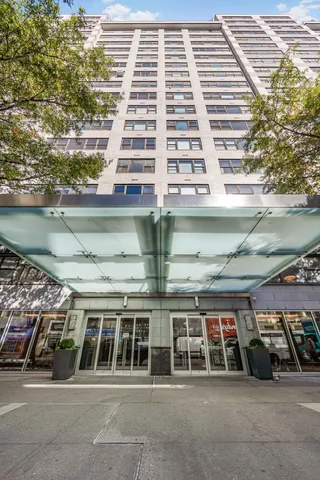 a view of a building with a lot of windows and trees