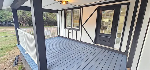 a view of a hallway with wooden floor and stairs