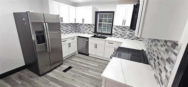 a kitchen with stainless steel appliances a refrigerator sink and microwave
