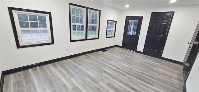 wooden floor in an empty room with a window