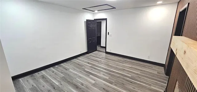 a view of a small space with wooden floor and staircase