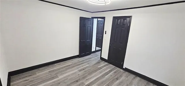 a view of hallway with wooden floor