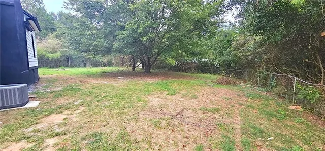a view of a yard with trees