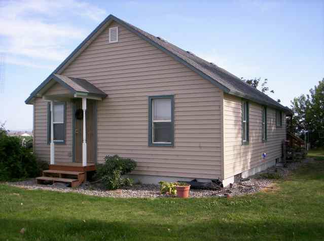 5990 Independence Road Sunnyside, WA 98944 - Photo 1 of 4 a front view of a house with a garden and yard