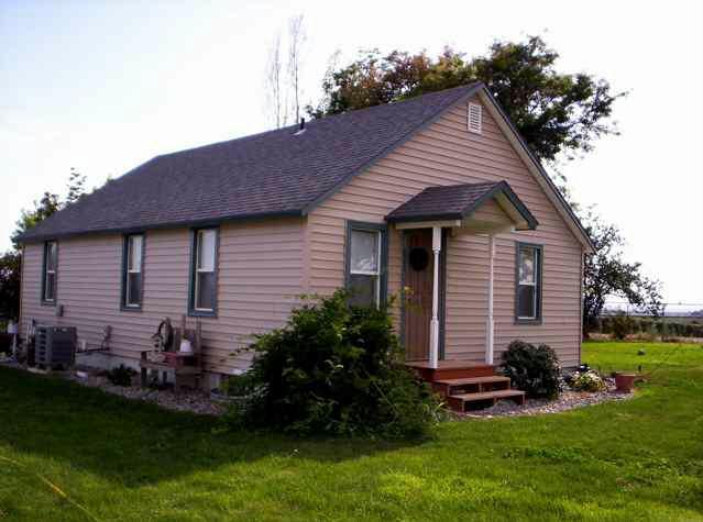 5990 Independence Road Sunnyside, WA 98944 - Photo 2 of 4 a front view of a house with a garden and yard