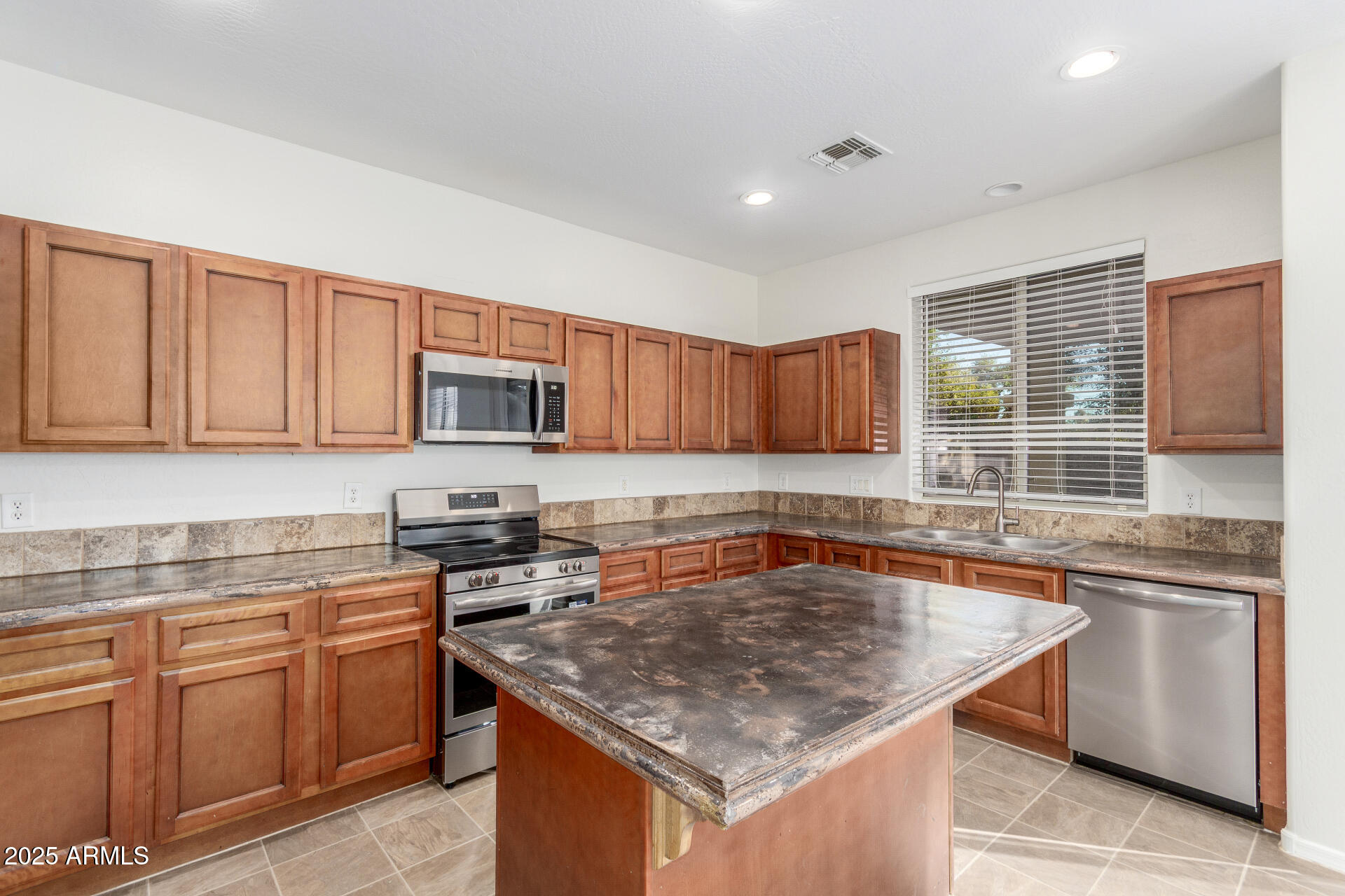 8849 West Cordes Road Tolleson, AZ 85353 - Photo 13 of 33 a kitchen with stainless steel appliances granite countertop a sink stove and microwave