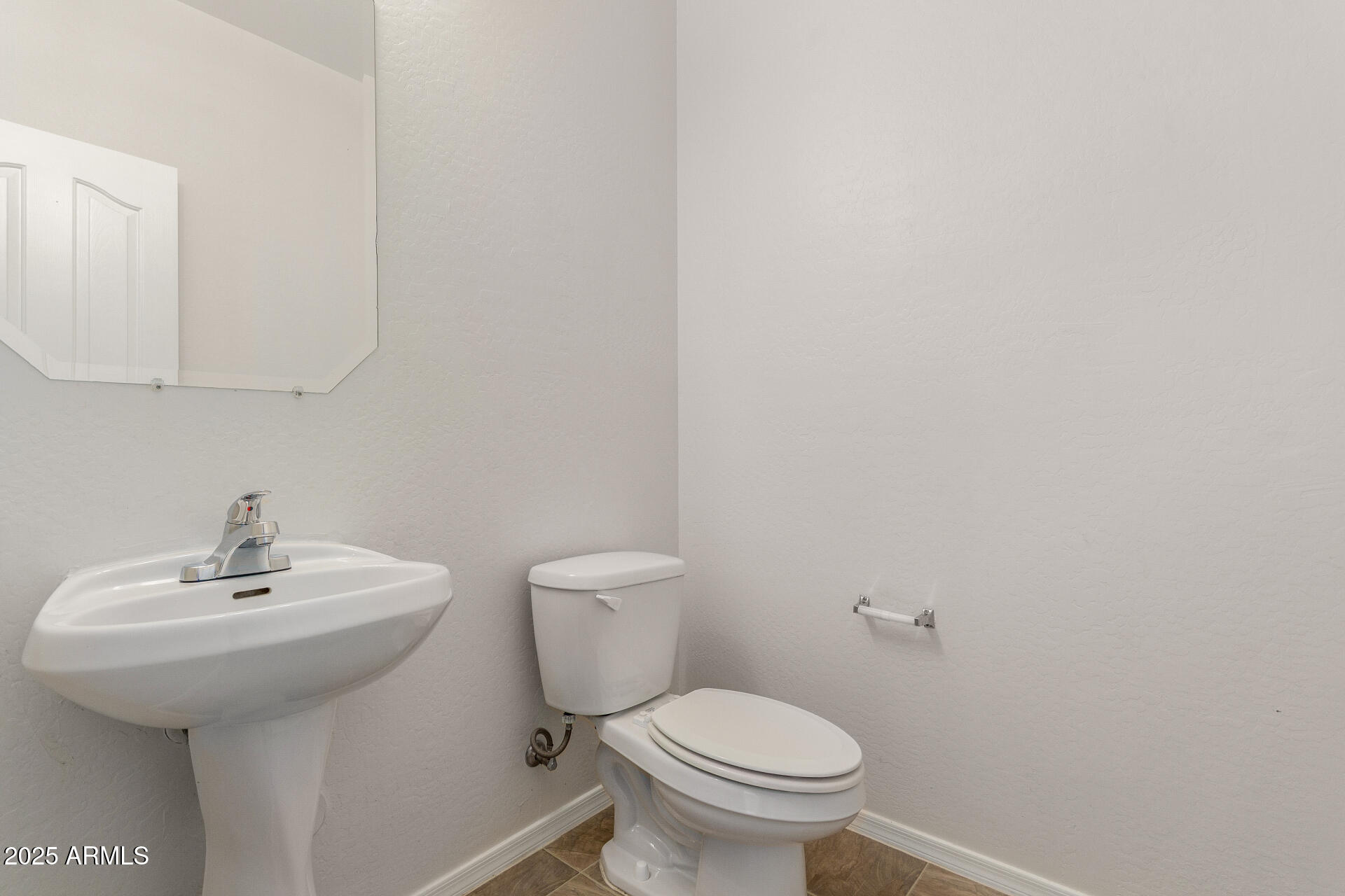 8849 West Cordes Road Tolleson, AZ 85353 - Photo 17 of 33 a bathroom with a sink and a toilet