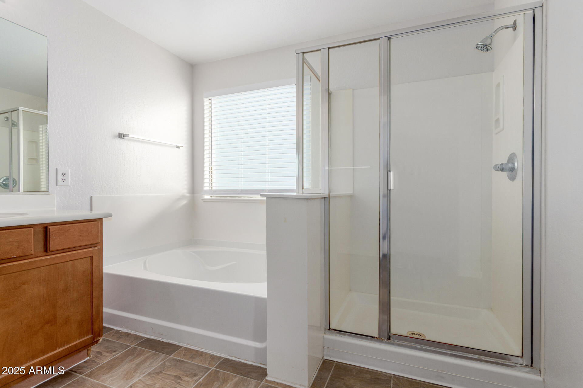8849 West Cordes Road Tolleson, AZ 85353 - Photo 22 of 33 a bathroom with a bathtub and a shower