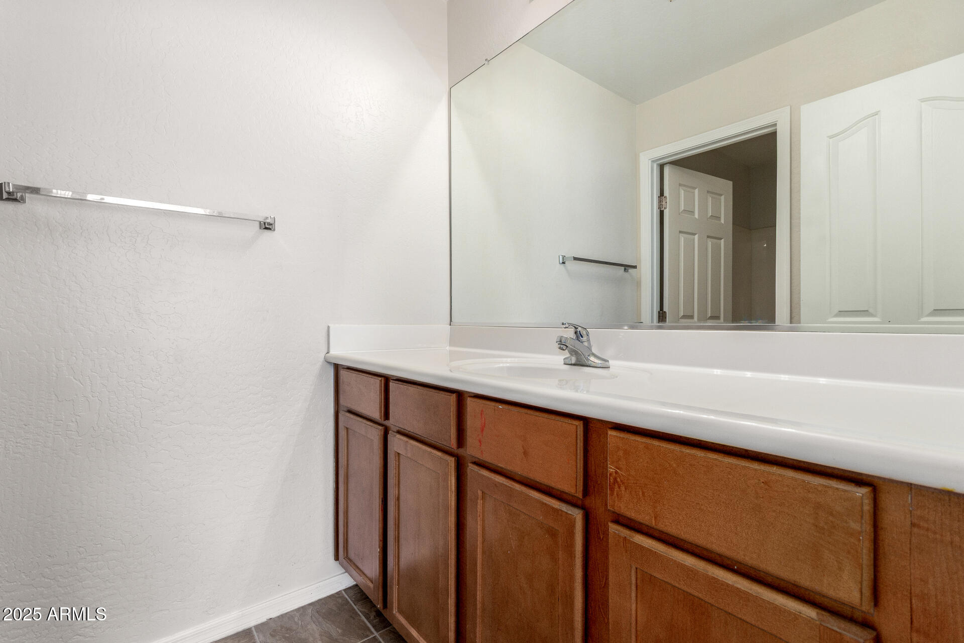 8849 West Cordes Road Tolleson, AZ 85353 - Photo 25 of 33 a bathroom with a double vanity sink and a mirror