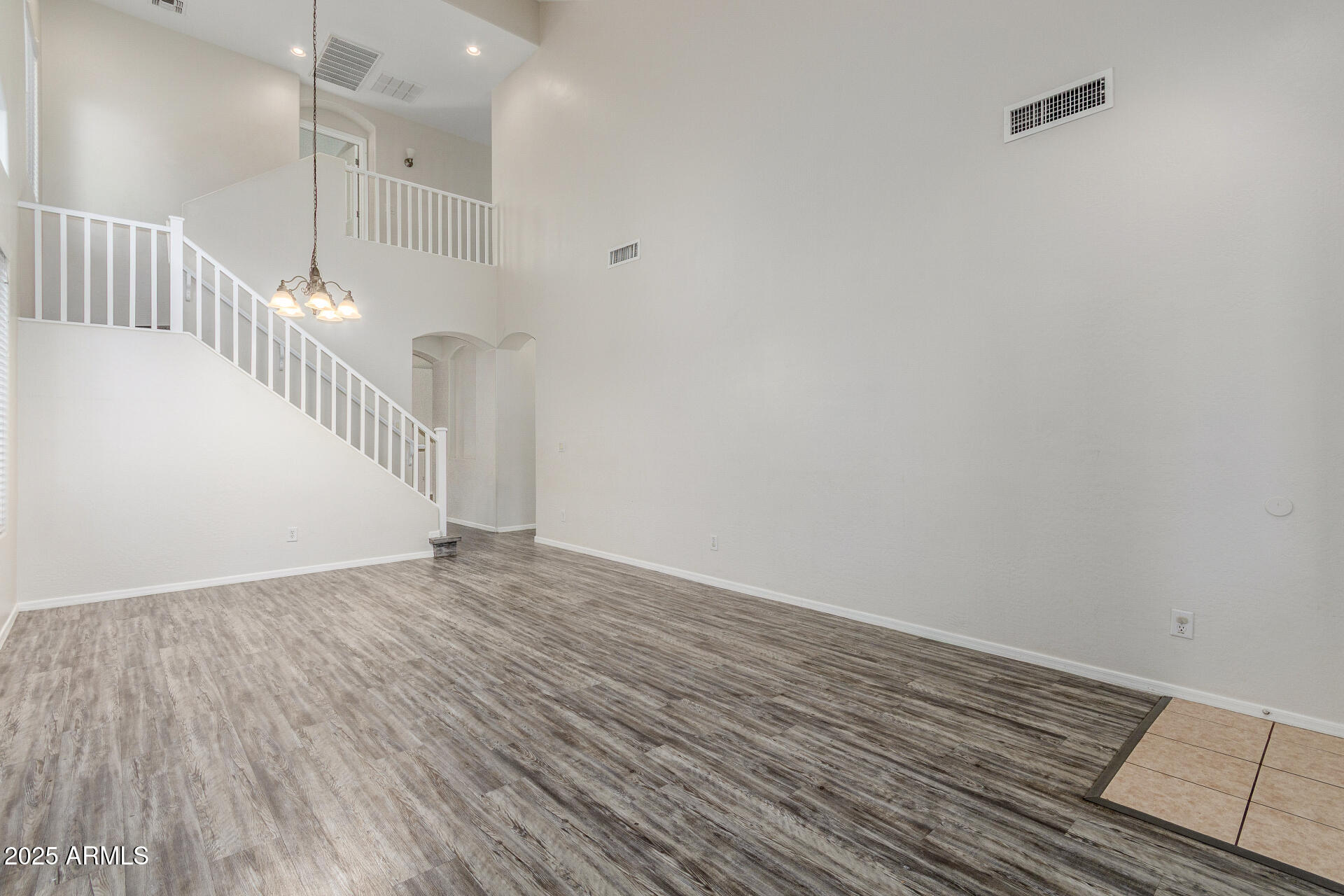 8849 West Cordes Road Tolleson, AZ 85353 - Photo 5 of 33 a view of an empty room with wooden floor