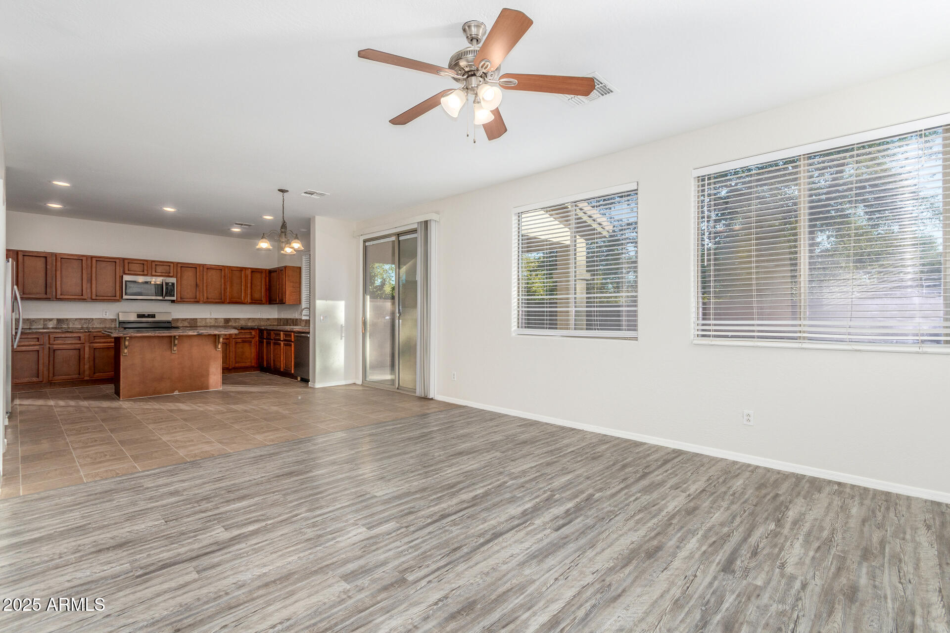 8849 West Cordes Road Tolleson, AZ 85353 - Photo 10 of 33 a view of an empty room with a kitchen and a window