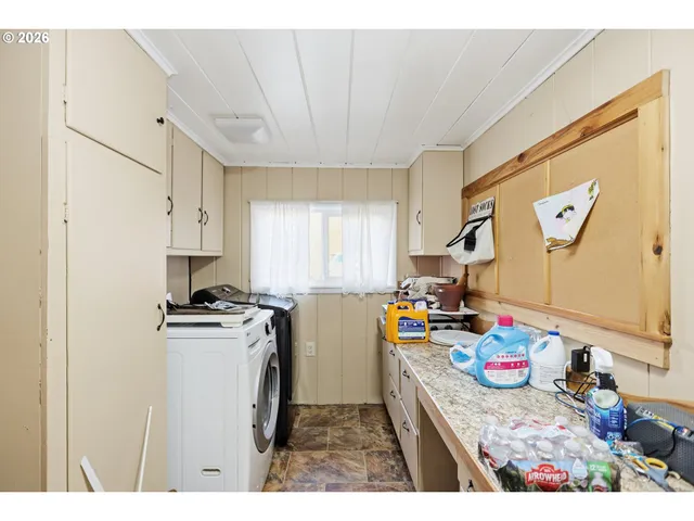 a kitchen that has a lot of cabinets a stove and a refrigerator