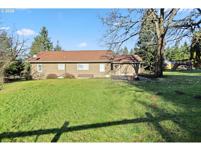 a view of house with backyard