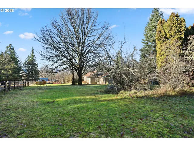 a view of a wooden fence and trees
