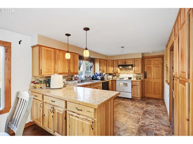 a kitchen with counter top space a sink and appliances