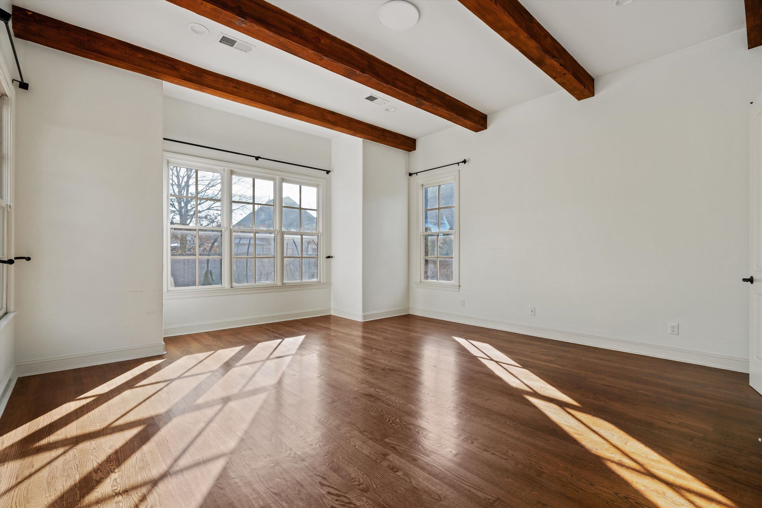 1247 Braywind Drive Collierville, TN 38017 - Photo 16 of 35 a view of an empty room with wooden floor and a window
