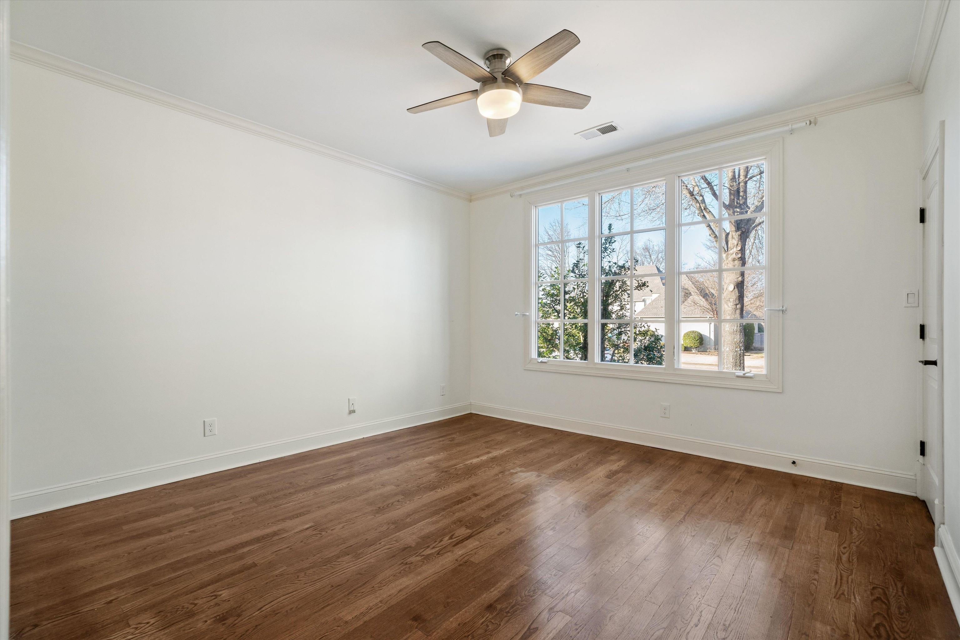 1247 Braywind Drive Collierville, TN 38017 - Photo 21 of 35 an empty room with wooden floor and windows