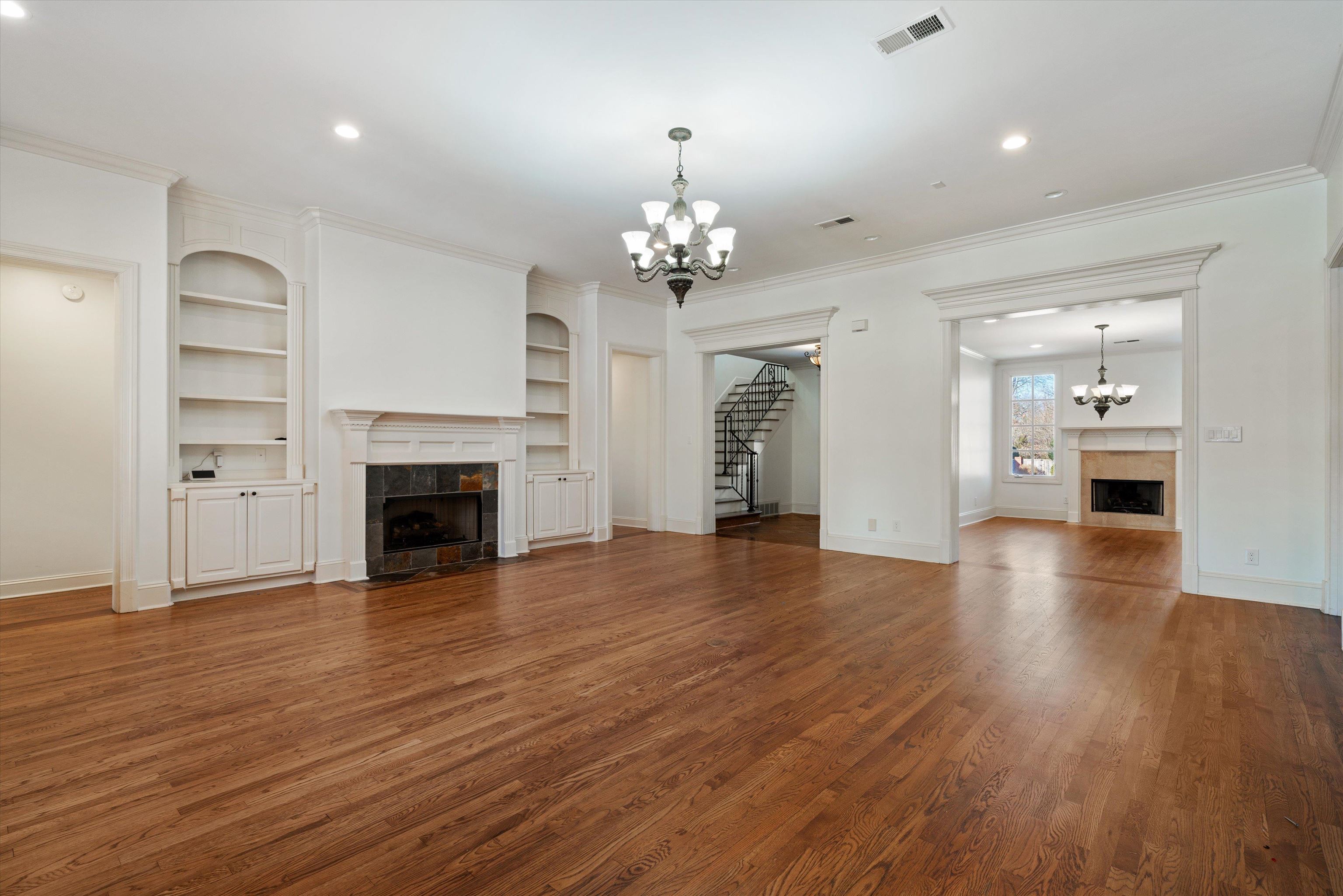1247 Braywind Drive Collierville, TN 38017 - Photo 4 of 35 an empty room with wooden floor fireplace and windows