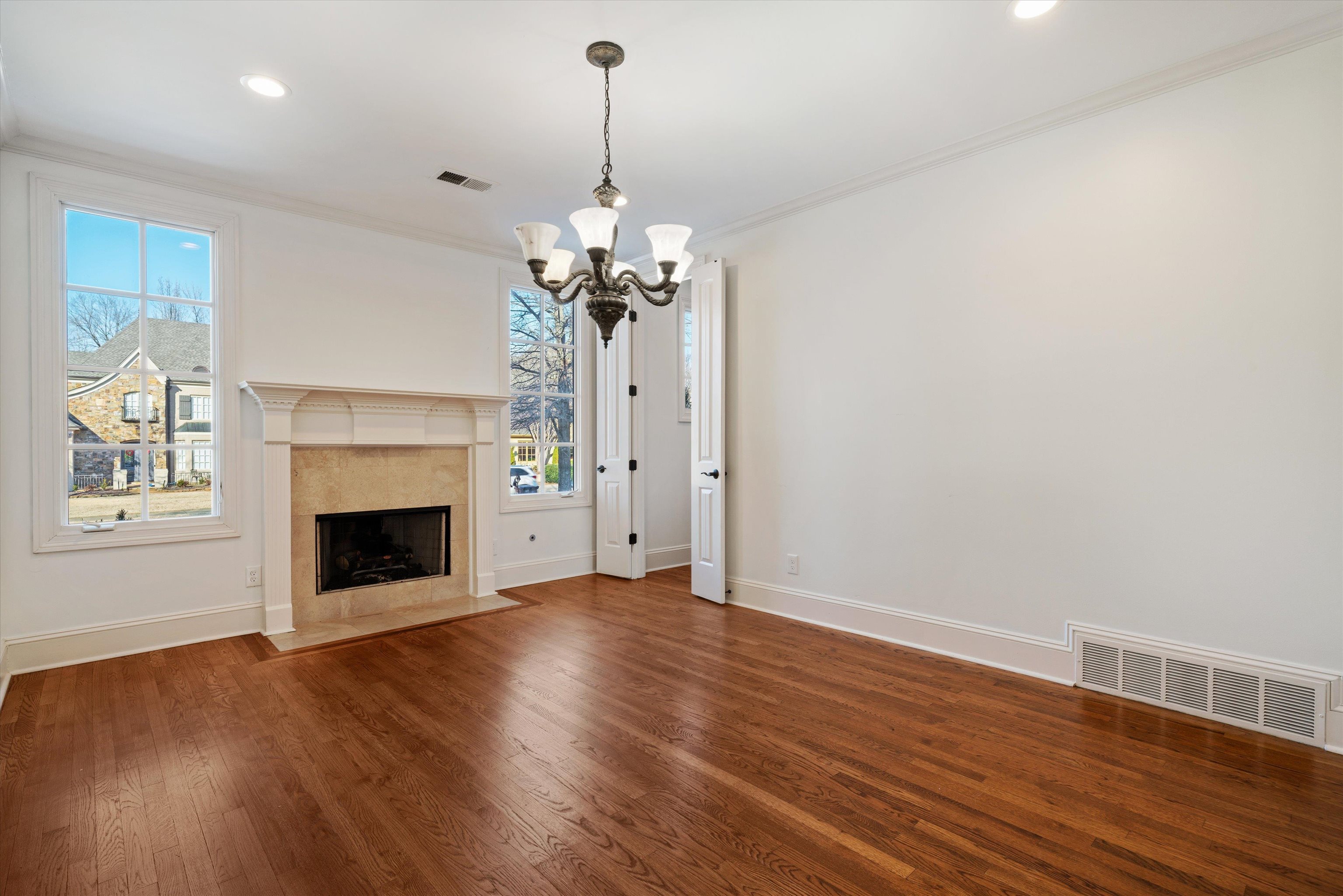1247 Braywind Drive Collierville, TN 38017 - Photo 5 of 35 a view of a livingroom with a chandelier wooden floor and a fireplace