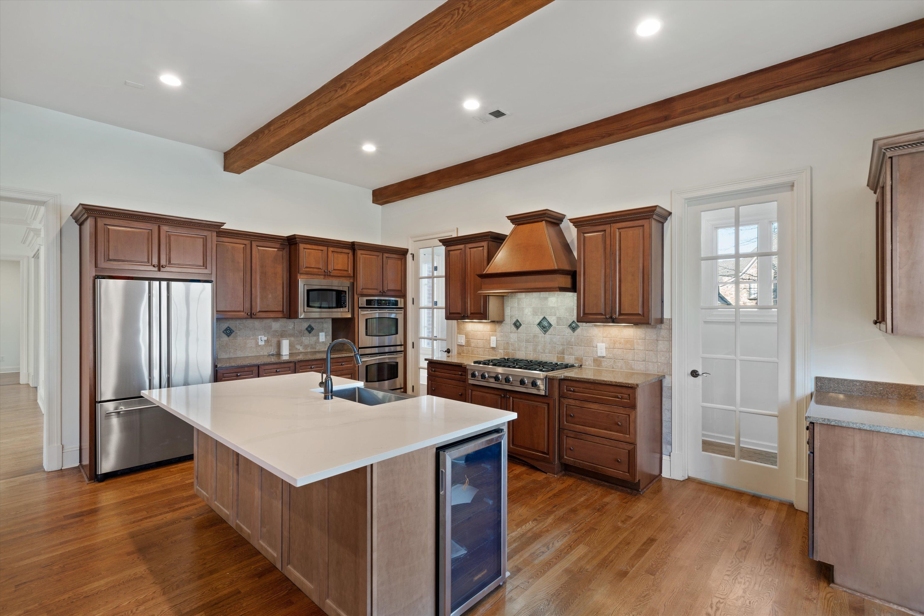1247 Braywind Drive Collierville, TN 38017 - Photo 6 of 35 a kitchen with stainless steel appliances granite countertop a sink stove and refrigerator