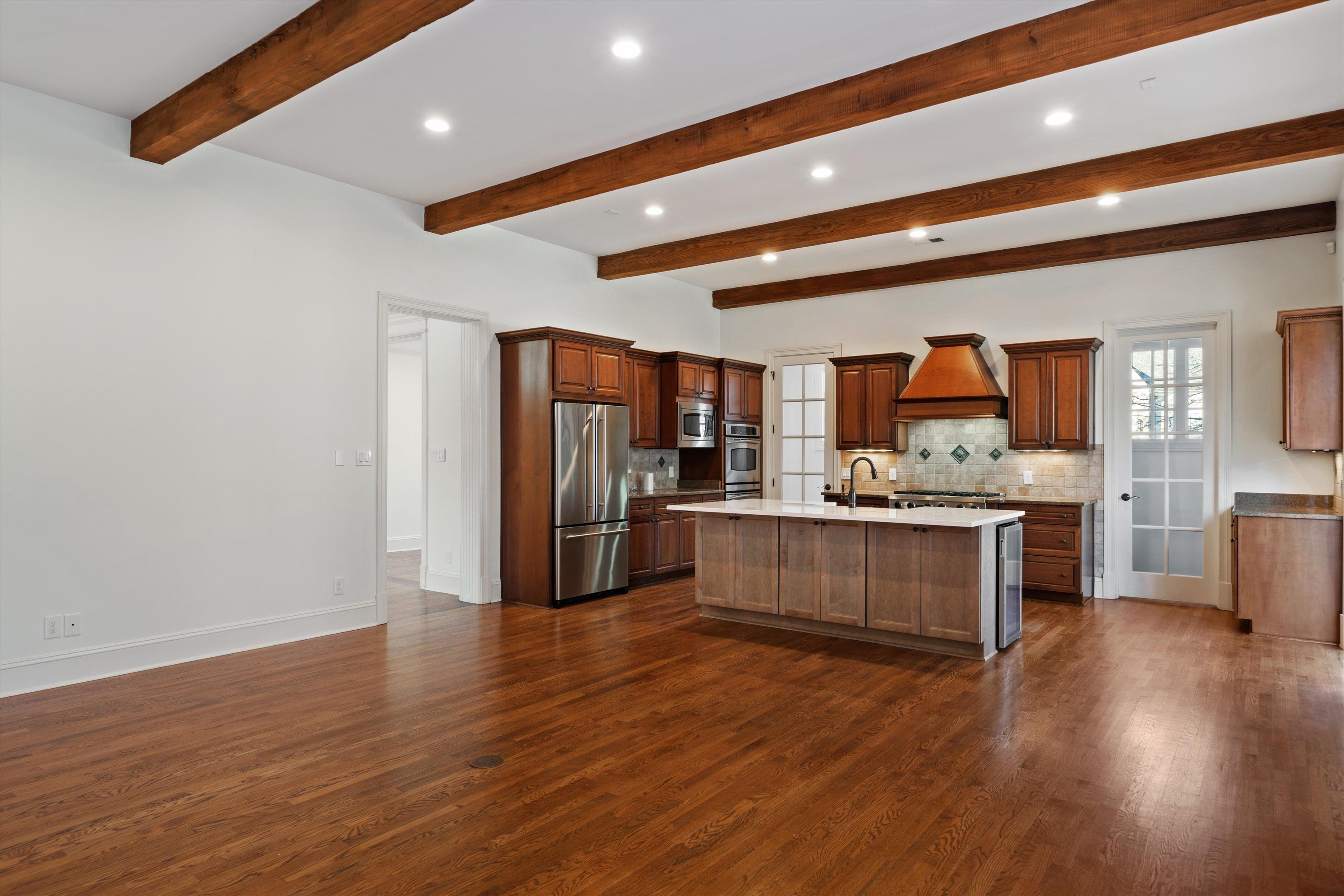 1247 Braywind Drive Collierville, TN 38017 - Photo 9 of 35 a large kitchen with a center island wooden floor and stainless steel appliances