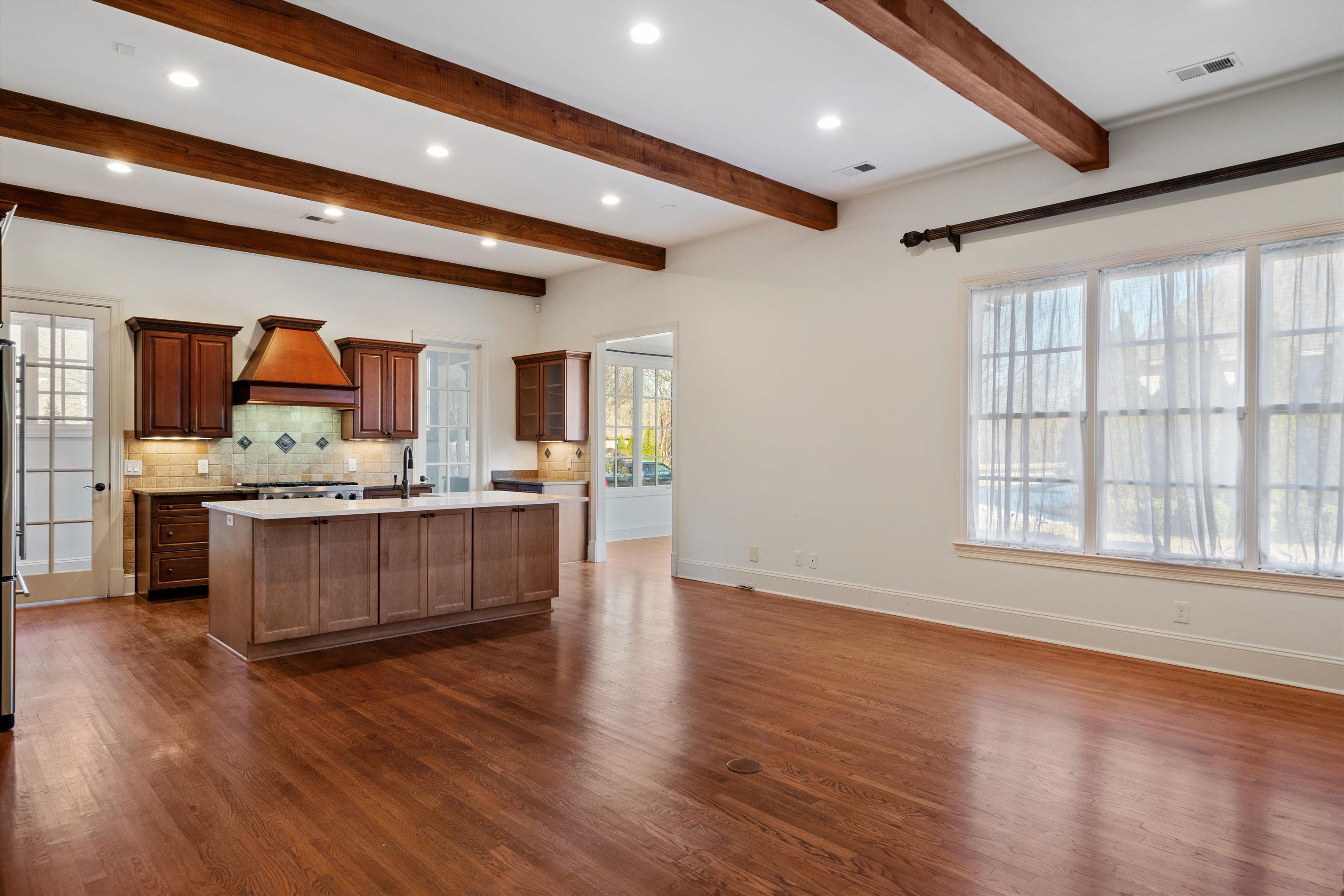 1247 Braywind Drive Collierville, TN 38017 - Photo 10 of 35 a large kitchen with stainless steel appliances wooden floors and large window