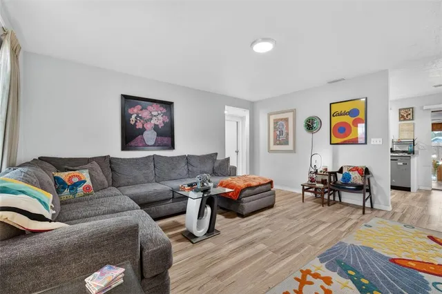 a bedroom with furniture and a wooden floor