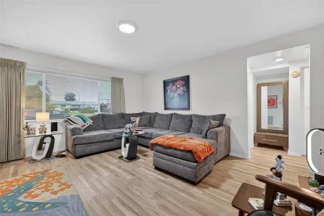 a living room with furniture a flat screen tv and a lamp