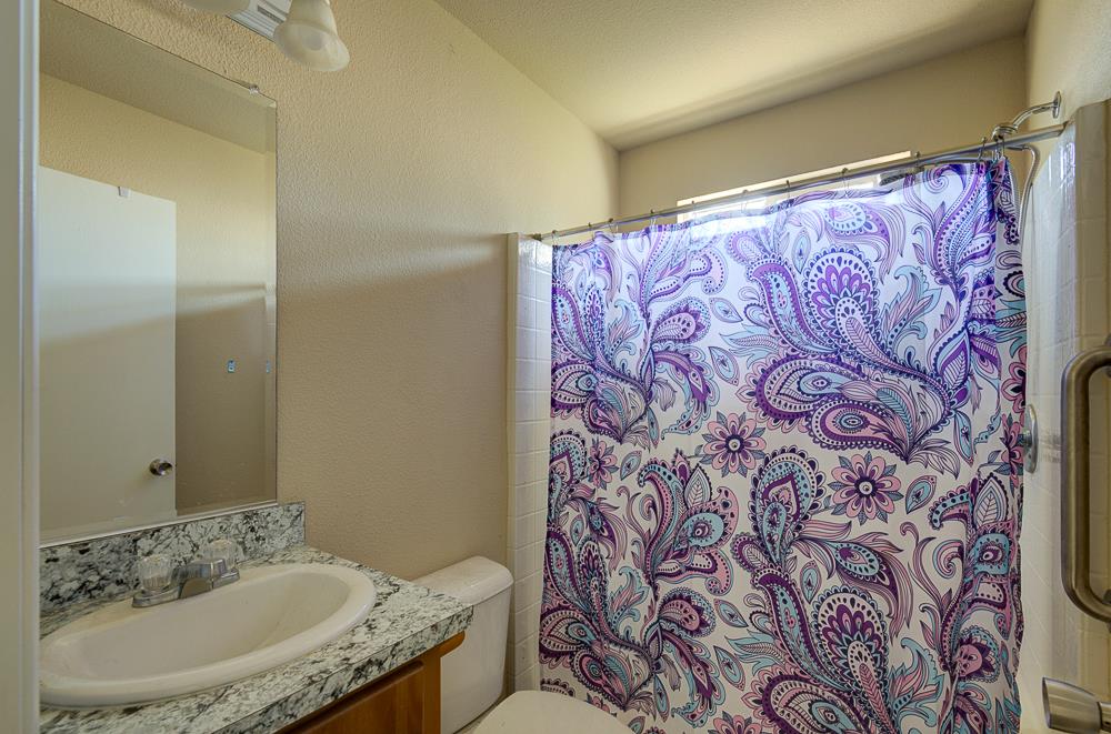 1218 East Cleveland Avenue, Unit 19 Madera, CA 93638 - Photo 17 of 18 a bathroom with a sink and a mirror