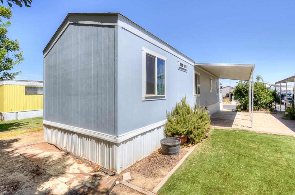 1218 East Cleveland Avenue, Unit 19 Madera, CA 93638 - Photo 4 of 18 a view of an house with backyard and patio