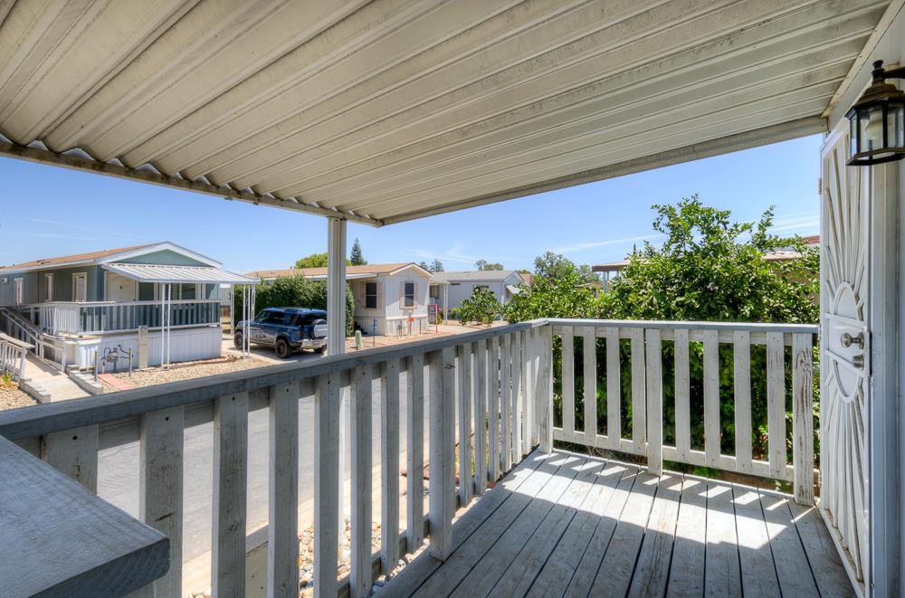 1218 East Cleveland Avenue, Unit 19 Madera, CA 93638 - Photo 6 of 18 a view of deck with furniture and garden