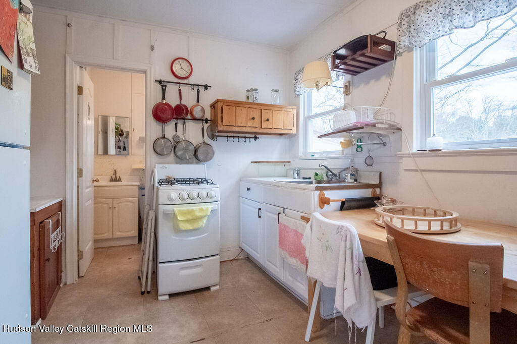 224 Camp Road Ellenville, NY 12428 - Photo 22 of 50 a kitchen with a stove a refrigerator and a table